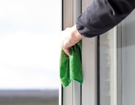 wiping a windowsill