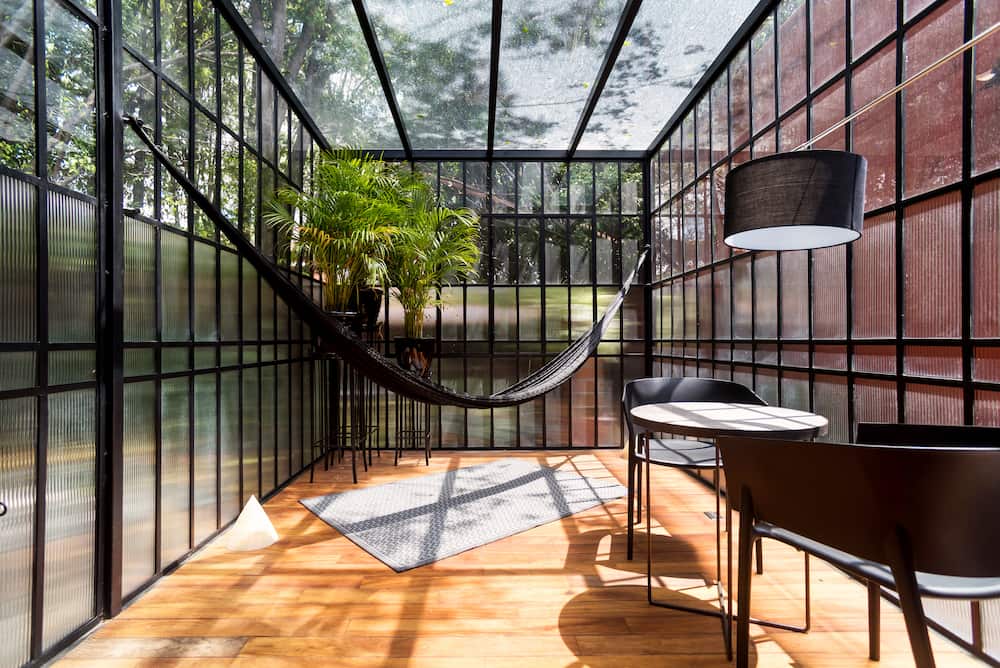 sunroom with hammock, table and chairs-home addition for more square footage