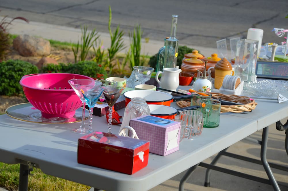 glassware items on a table at a garage sale
