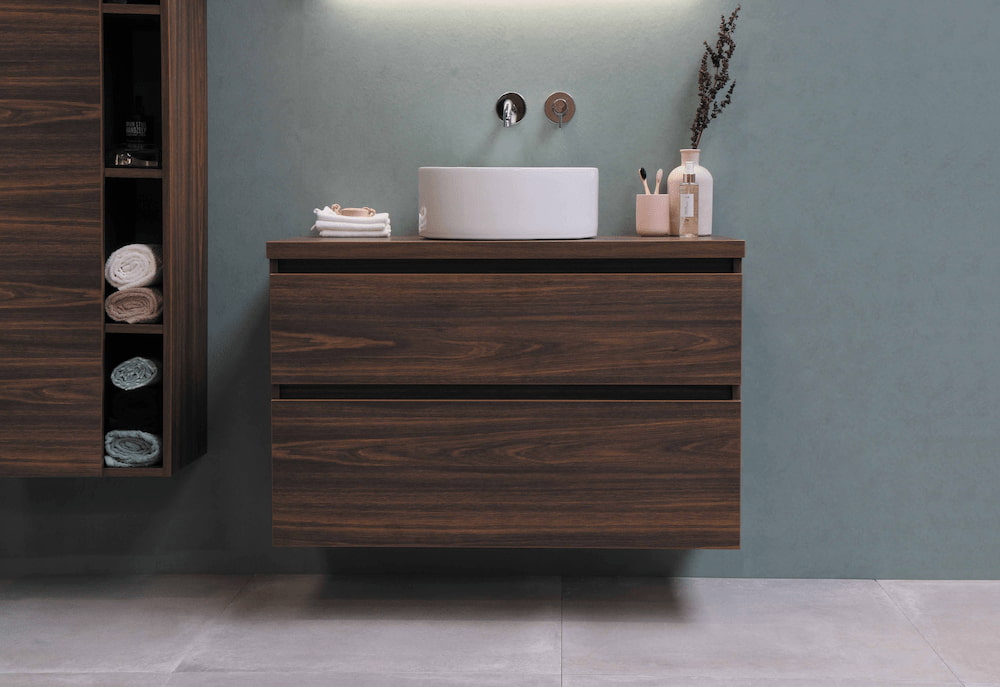 clean and decluttered dark wood bathroom vanity with white sink 