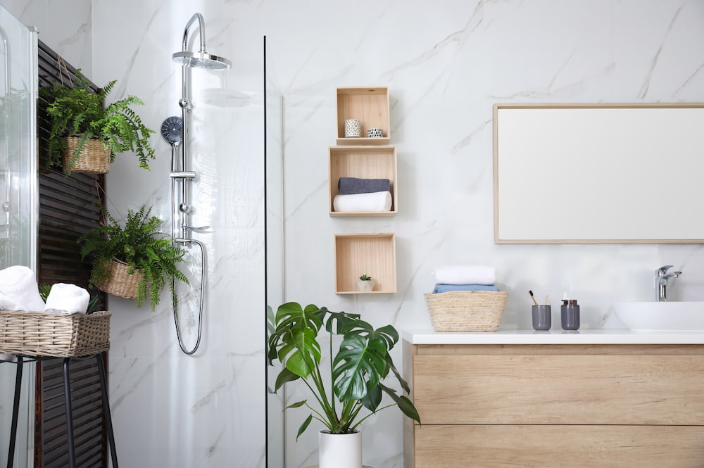 decluttered and organized bathroom with plants and hanging cube shelves