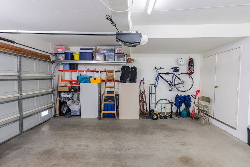 decluttered and organized garage with shelving and hanging bike rack
