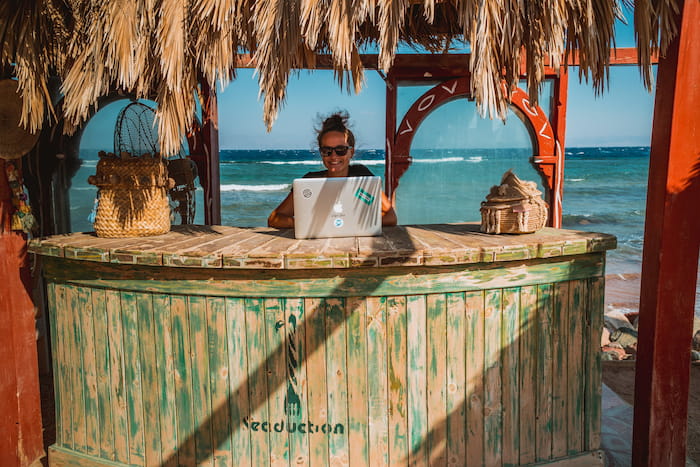 a digital nomad works from the beach