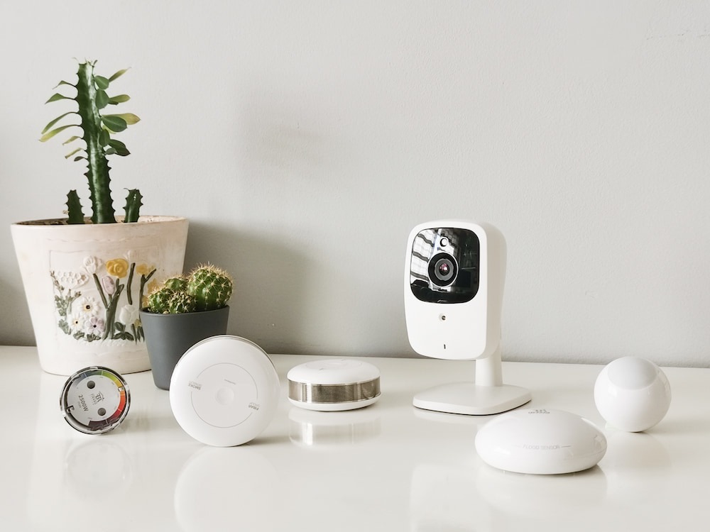 a variety of smart home gadgets sitting on a white counter for a home improvement project