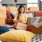 Someone putting items in a box