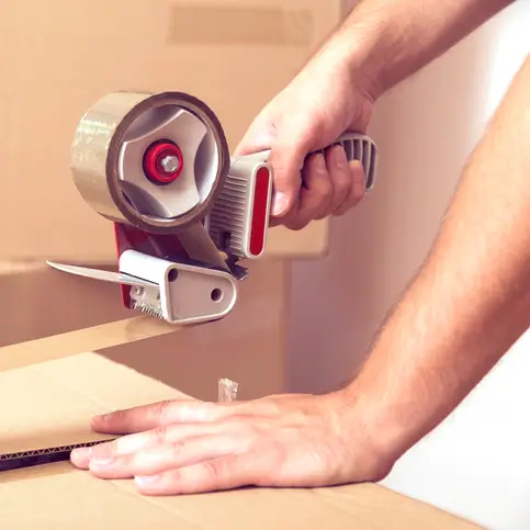 Someone taping a box shut.