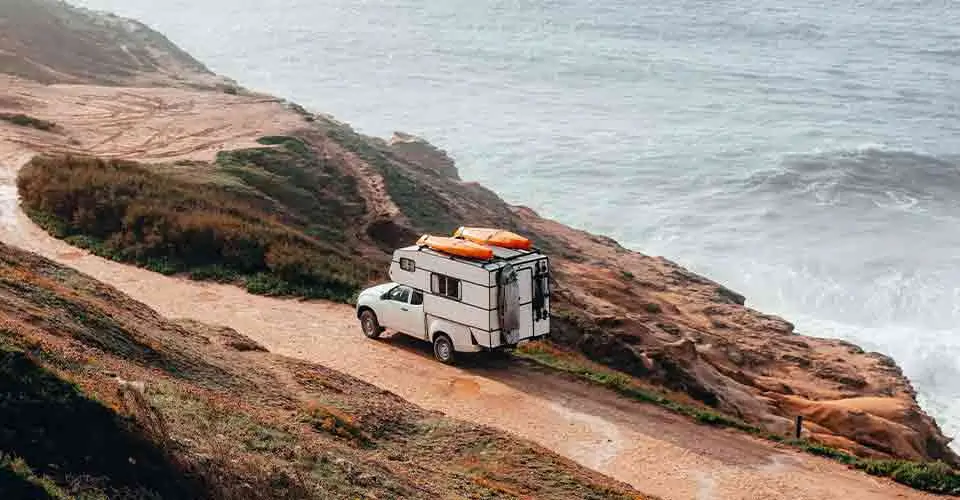 white truck camper on the road near the oven after being stored in camper storage