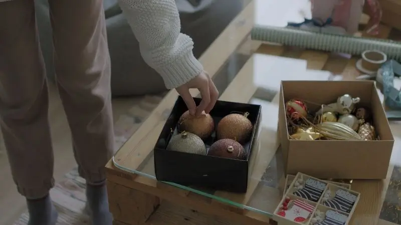 christmas ornaments being packed in boxes