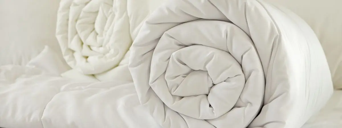 comforter rolled tightly for storage in small spaces