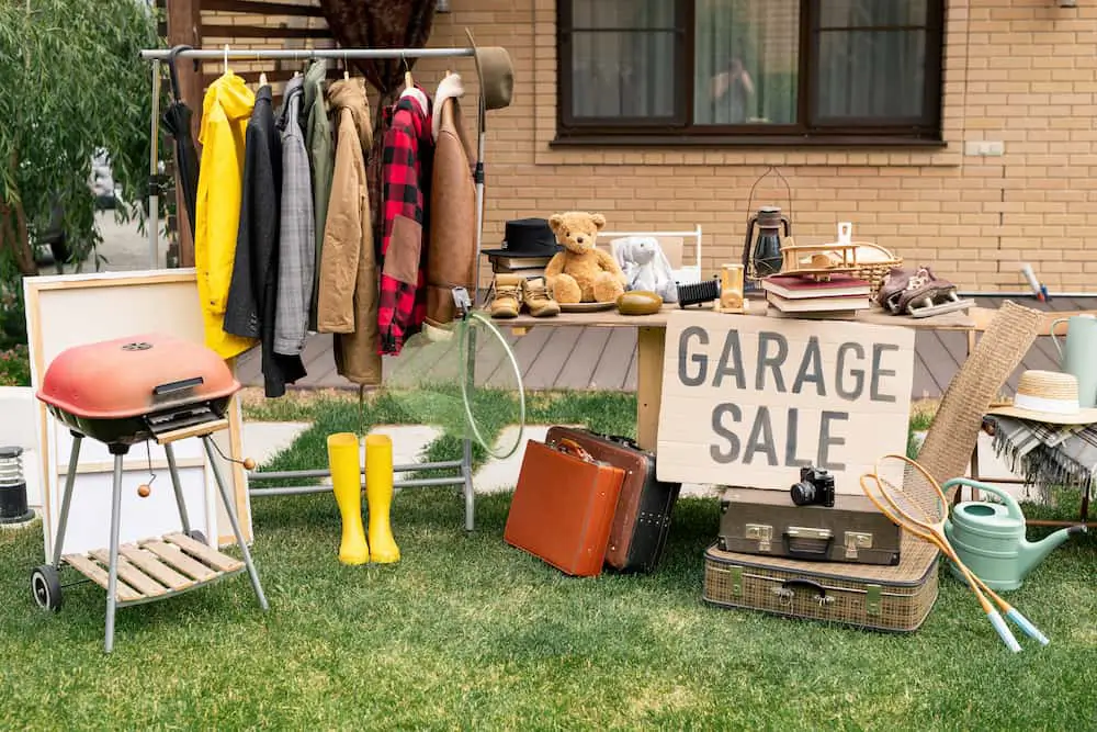 clothing rack and various items set up for a garage sale