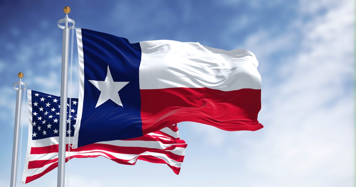 flag of Texas flies next to American flag