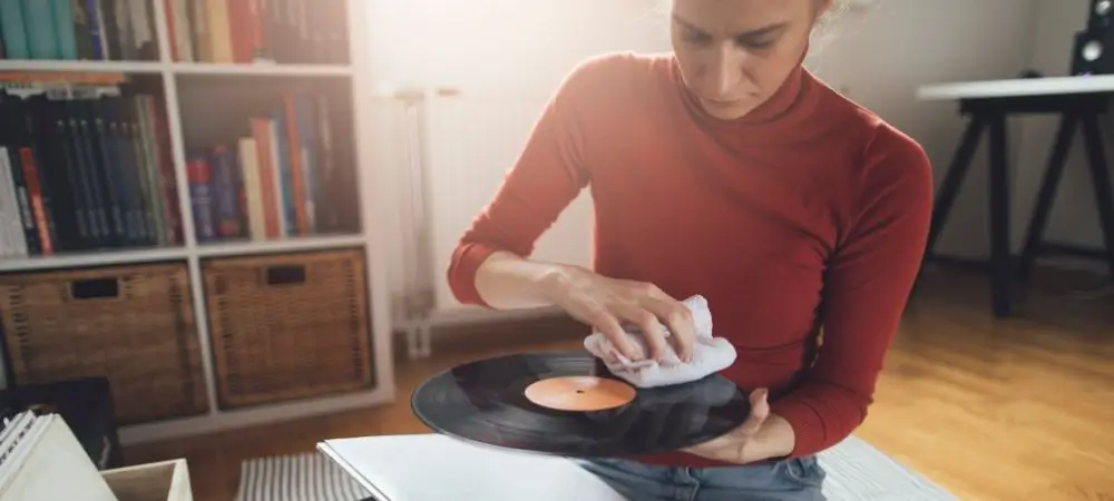 woman cleaning and storing records