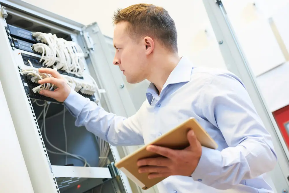 I.T. worker looking at electronical in an office preparing to move to a new location