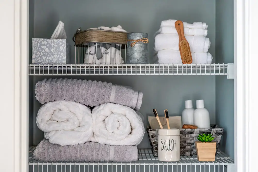 An organized closet with towels and toiletries.
