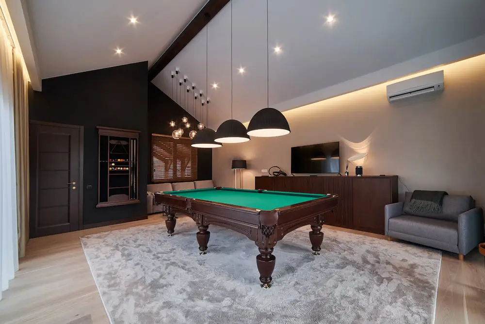 large man cave with pool table in the center