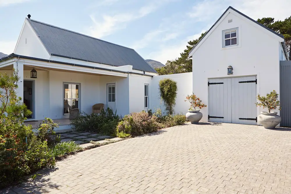 modern white home and detached garage that has undergone home improvement projects