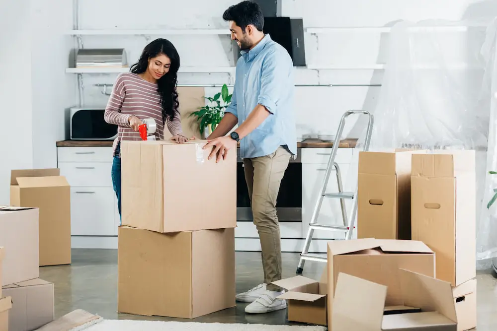 couple packing moving boxes