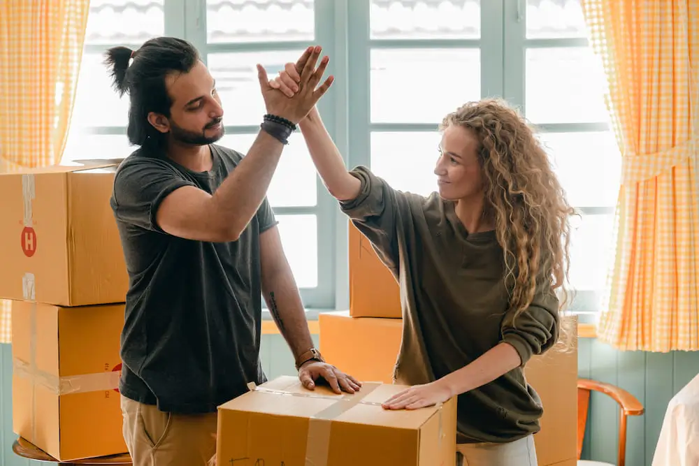 A couple high fives after moving in together.