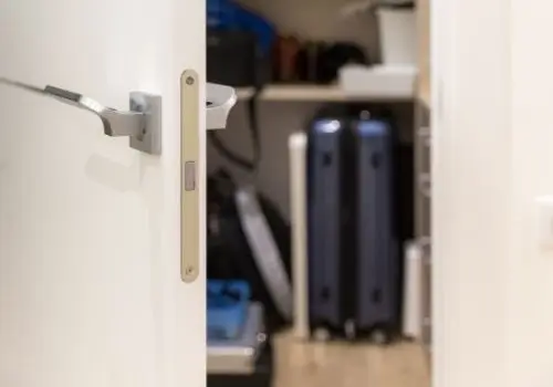 open door with suitcase storage